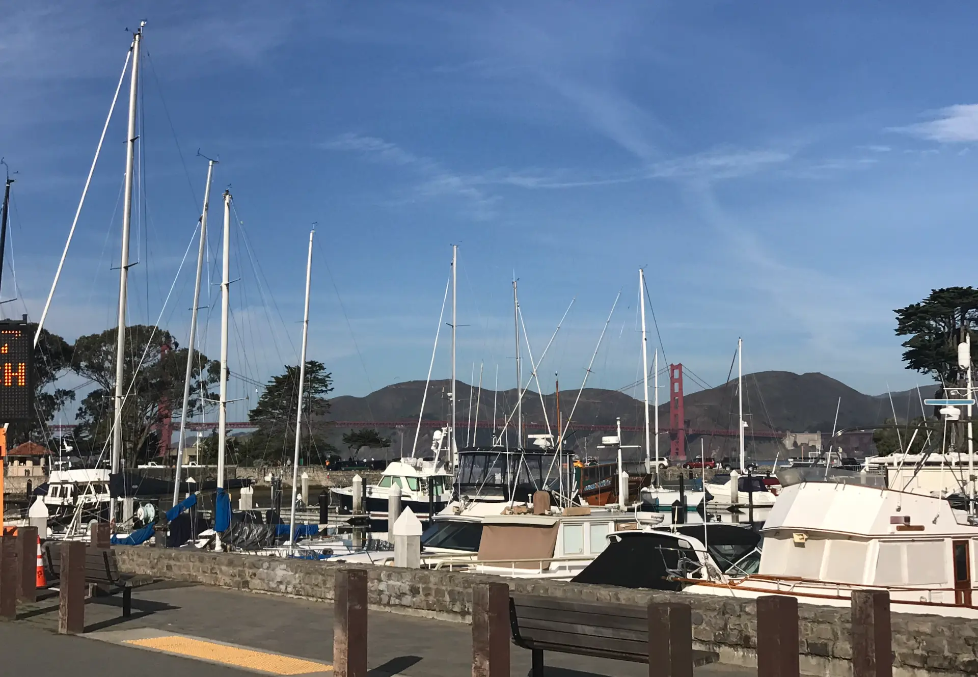 Masts of the yacht harbor with the Golden Gate Bridge beyond