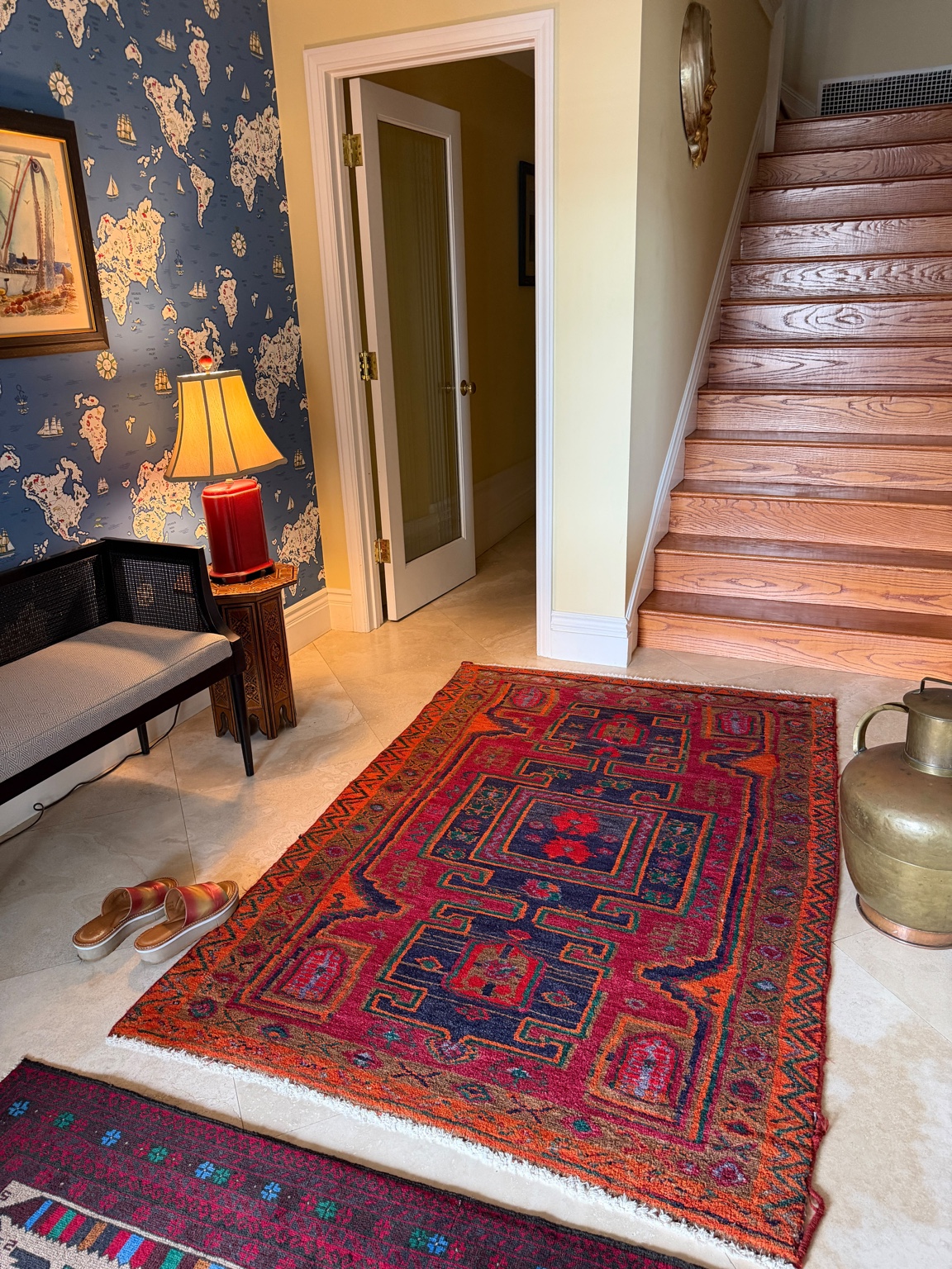 Entry hall with decorative rug and staircase